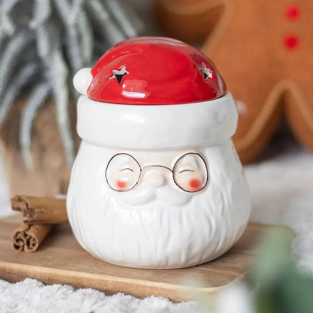 Keramische waxburner in de vorm van een kerstman met afneembare muts waar je waxmelts in kunt smelten. Kerst 2025 waxwarmer kleur rood met wit
