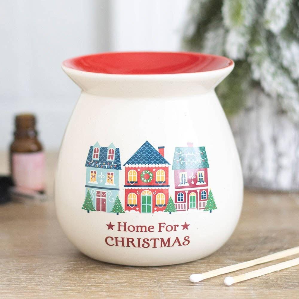 Met de Home for Christmas Geurbrander haal je instant gezelligheid in huis! Deze keramische geurbrander is afgewerkt met een lieflijk dorpsmotief en een warme rode binnenkom, de ultieme blikvanger voor de feestdagen.
