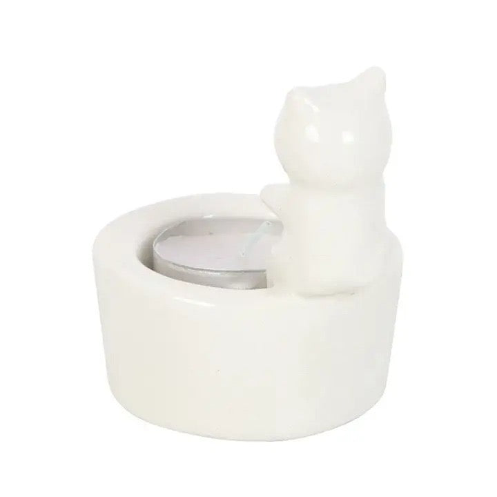 Witte keramische theelichthouder met een 3D katje en de tekst Warm Paws, Happy Heart waarin een waxinelichtje brandt Achterkant 