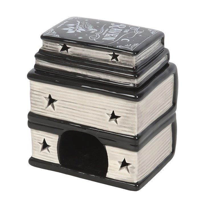 Keramische waxbrander vormgegeven als een zwarte stapel spreukenboeken met goudkleurige details en titels zoals 'Book of Spells' en 'The Raven'.